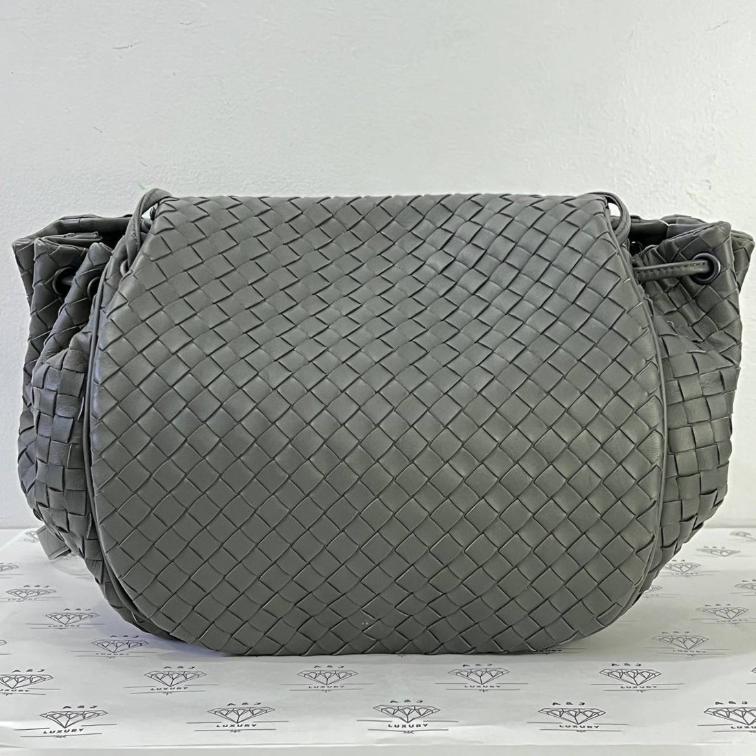 [PRE LOVED] Bottega Veneta Drawstring Flap in Gray Intrecciato Leather